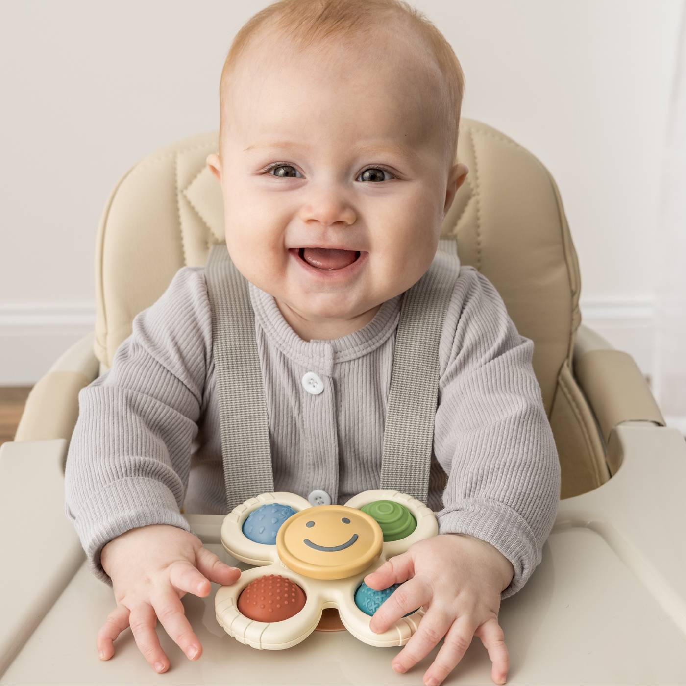 Itzy Ritzy Pop & Whirl Smile Spinner Fidget Toy; image 2 of 5