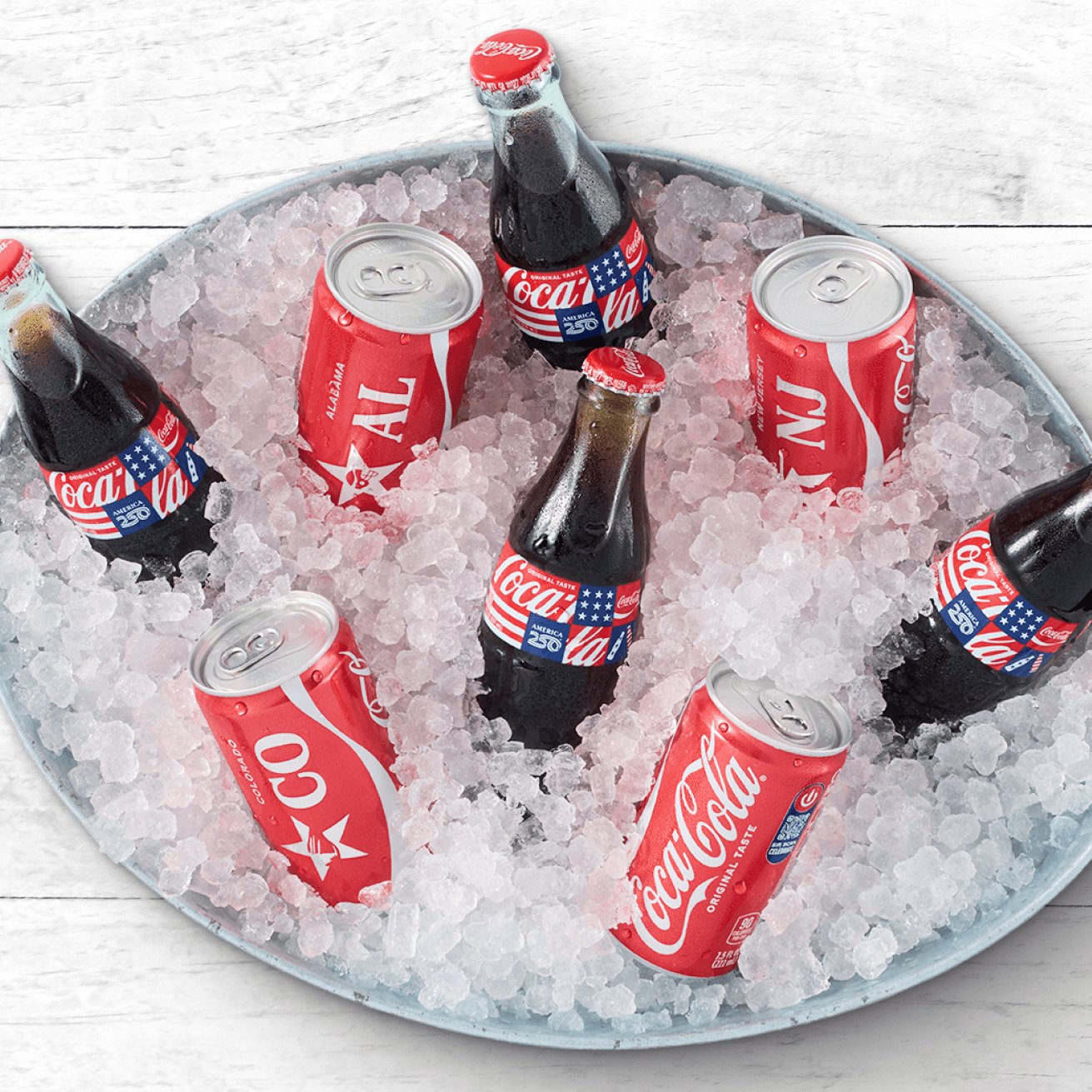 Coke bottles and cans in a bucket of ice