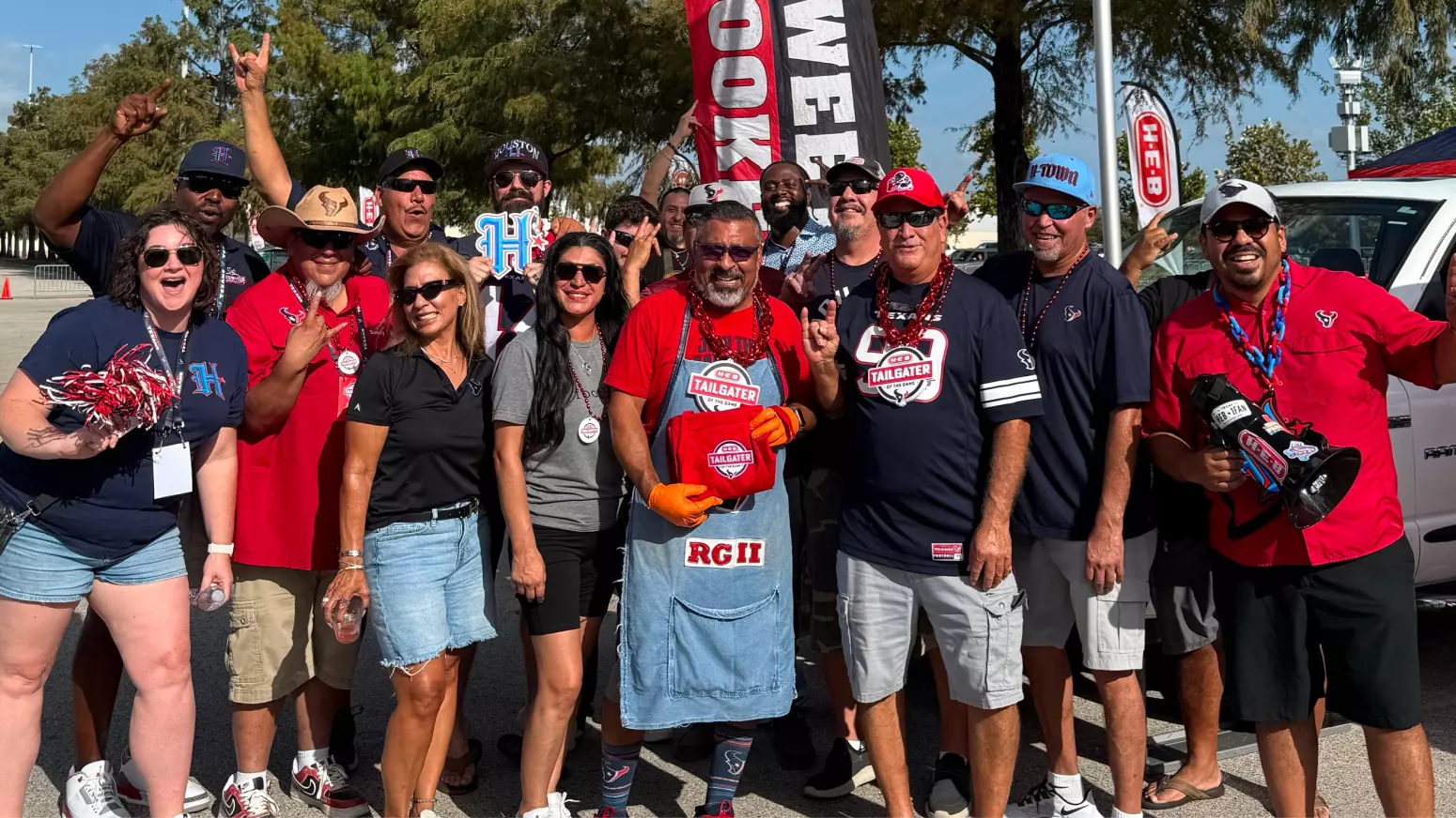 Houston Texans fans tailgating at an H‑E‑B Game Day Headquarters event before a football game.