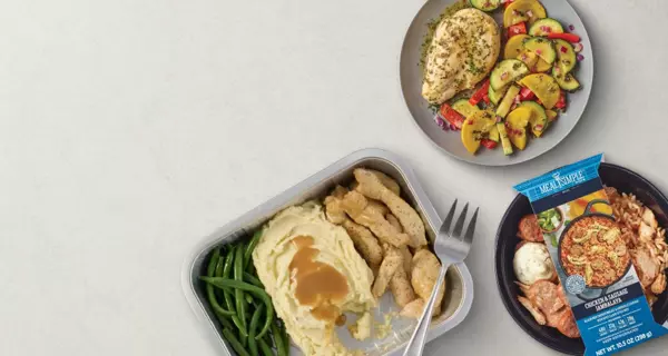 Banner featuring a Meal Simple turkey dinner with sliced turkey, mashed potatoes with gravy, and green beans in a meal tray. A packaged Meal Simple entrée and roasted vegetables are shown alongside. Text reads: “Meal Simple for busy nights.”