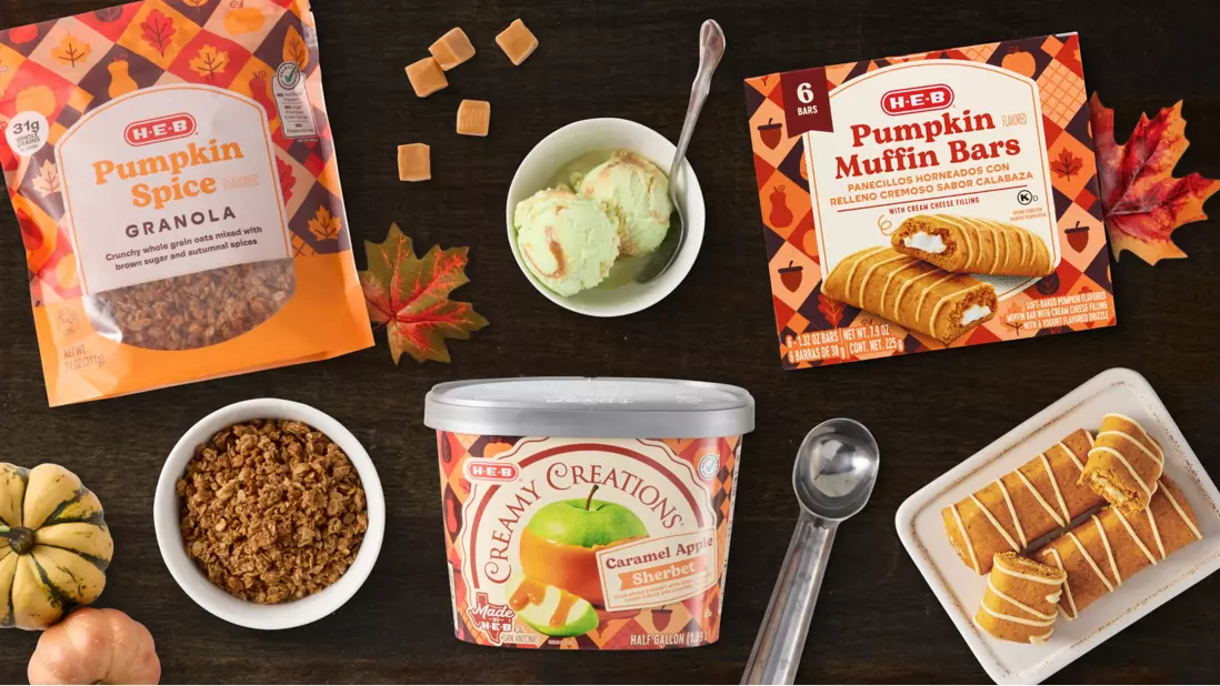 Fall-themed dessert spread featuring H‑E‑B Pumpkin Spice Granola, Pumpkin Muffin Bars, and Caramel Apple Sherbet. Served with ice cream, granola, caramel candies, and sliced bars on a dark wood table with pumpkins and autumn leaves.