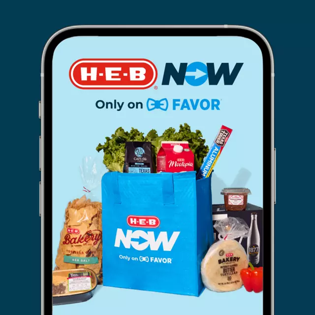 H‑E‑B Now powered by Favor app displayed on a smartphone screen, showcasing a blue grocery bag filled with fresh produce, snacks, and beverages.