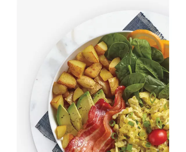 Breakfast hash with egg, bacon, avocado, spinach, and potato